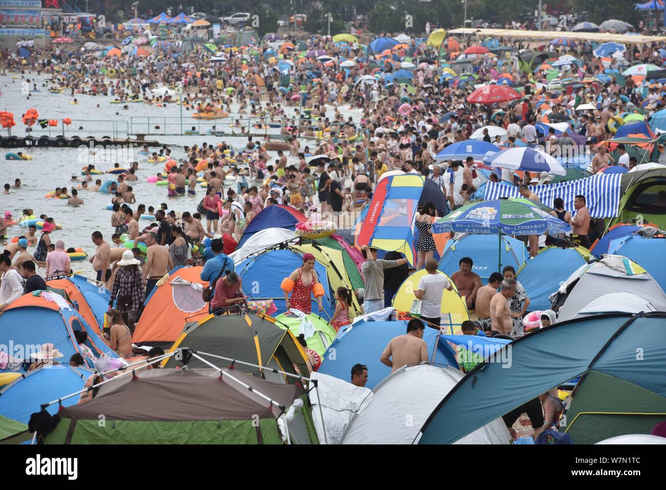 Holidaymakers crowd a beach resort to cool off on a scorching day in ...