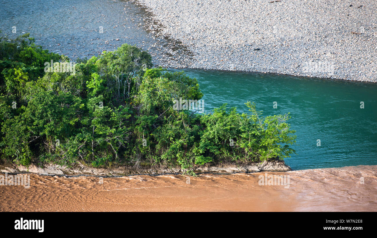 Water polluted by mercury from gold mining processes joins clean water of the Mapiri River, part of the upper reaches of the Amazon, Bolivia, November Stock Photo
