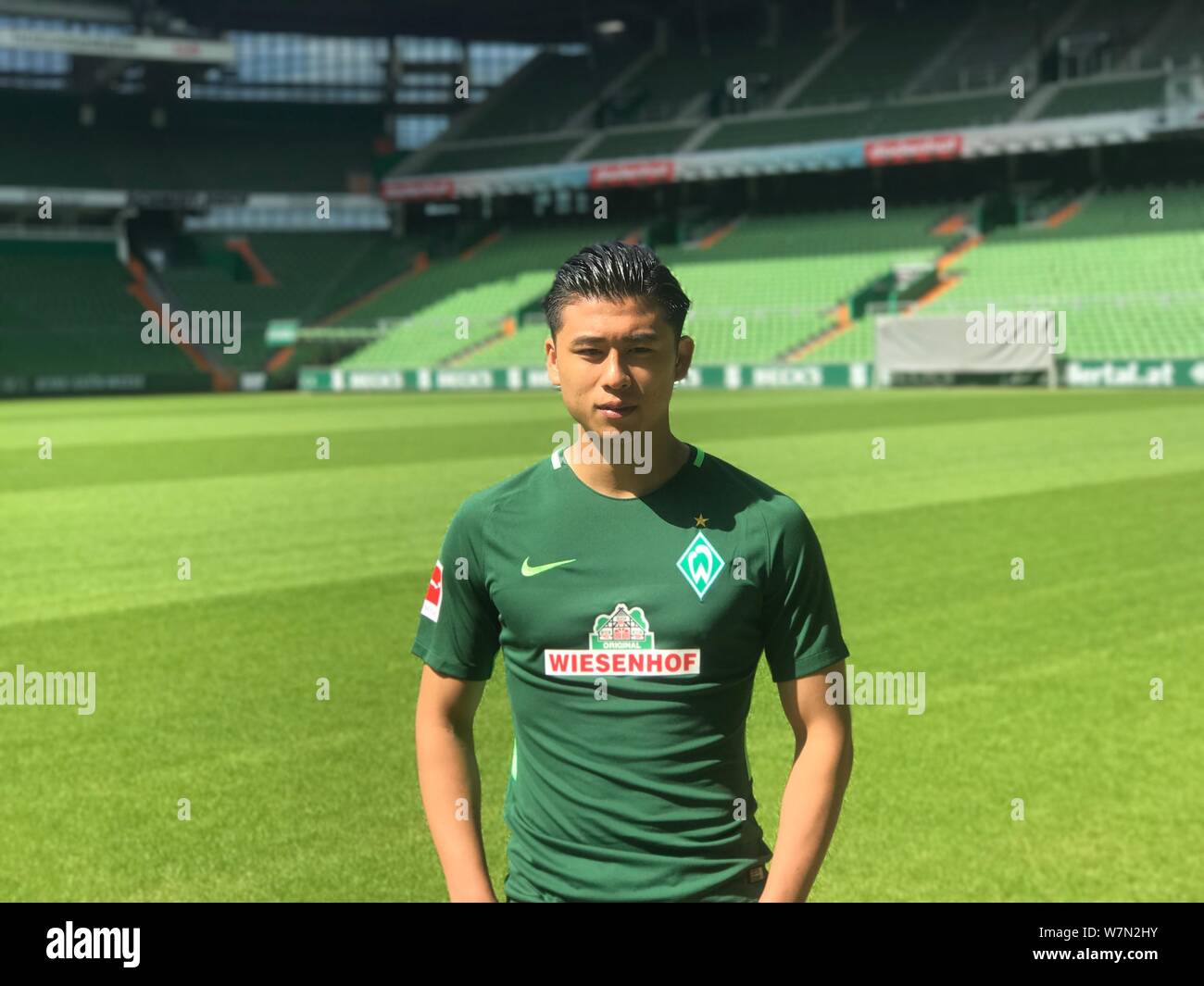 Chinese striker Zhang Yuning wears his new soccer jersey of Werder Bremen after West Bromwich Albion signed him from Vitesse Arnhem and loaned him to Stock Photo