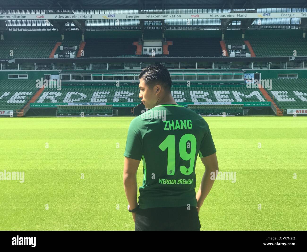 Chinese striker Zhang Yuning wears his new soccer jersey of Werder Bremen after West Bromwich Albion signed him from Vitesse Arnhem and loaned him to Stock Photo