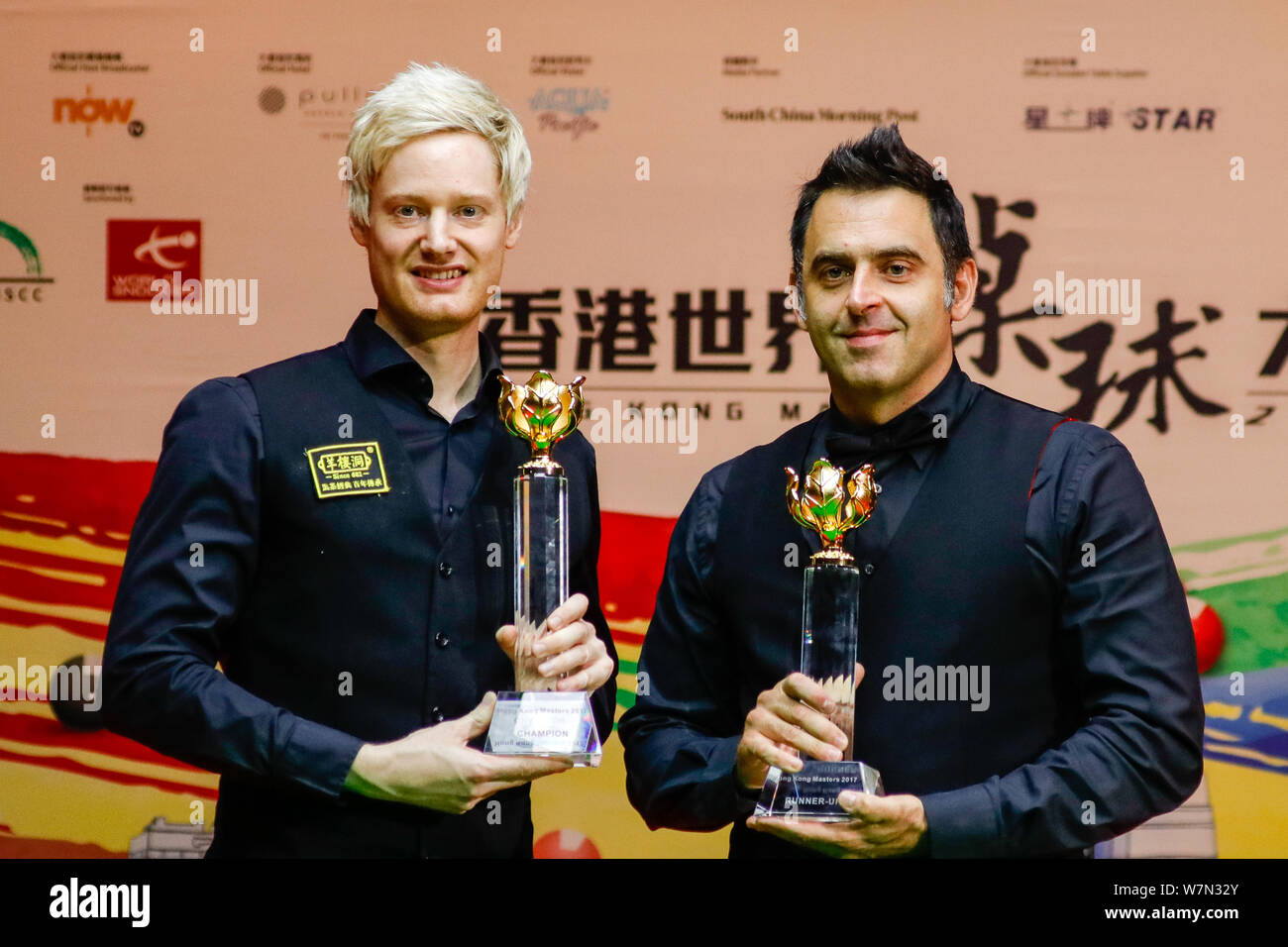 Neil Robertson, left, of Australia, and Ronnie OSullivan of England pose with their trophy during the award ceremony after Neil Robertson defeating R Stock Photo