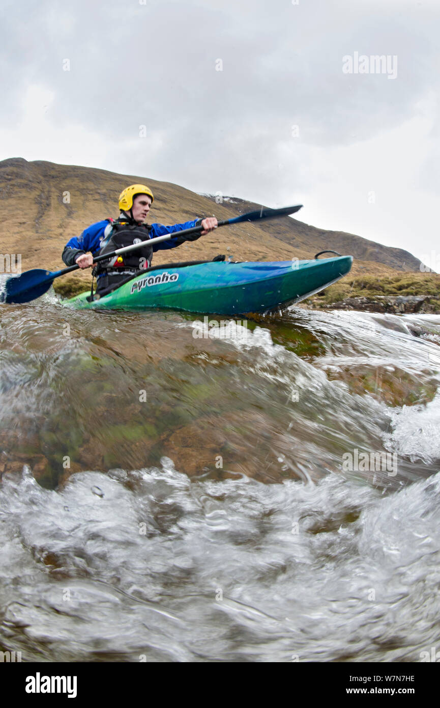 Kayaker in the River Etive, Highlands, Scotland, UK, April 2012. Stock Photo