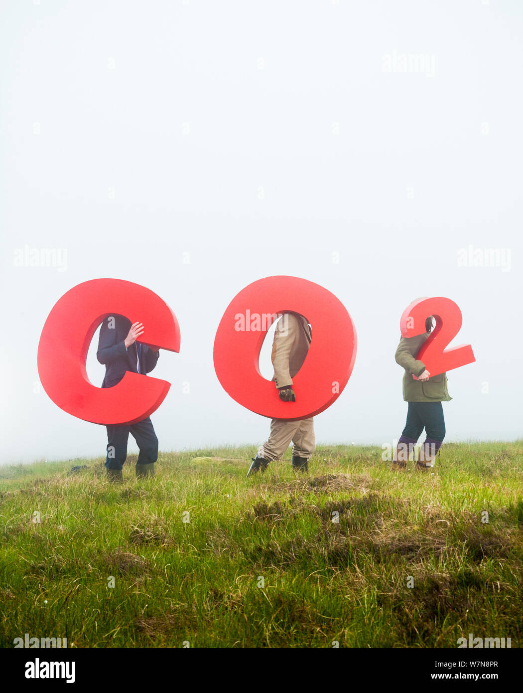 People holding signs spelling CO2, representing carbon capture for peatland burial. Sutherland, Scotland, July 2012. Stock Photo