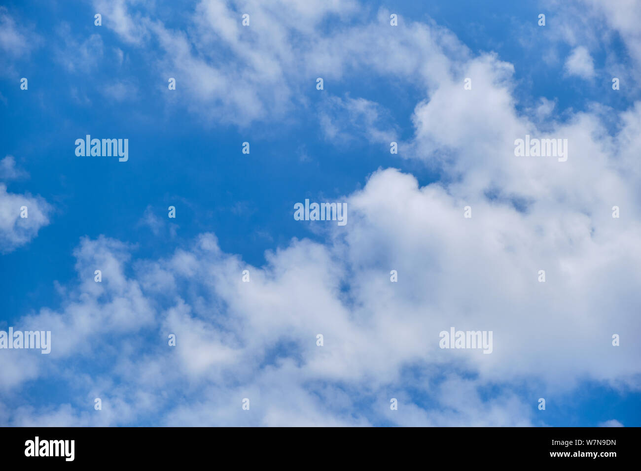 White clouds in the blue sky on a sunny day. Stock Photo