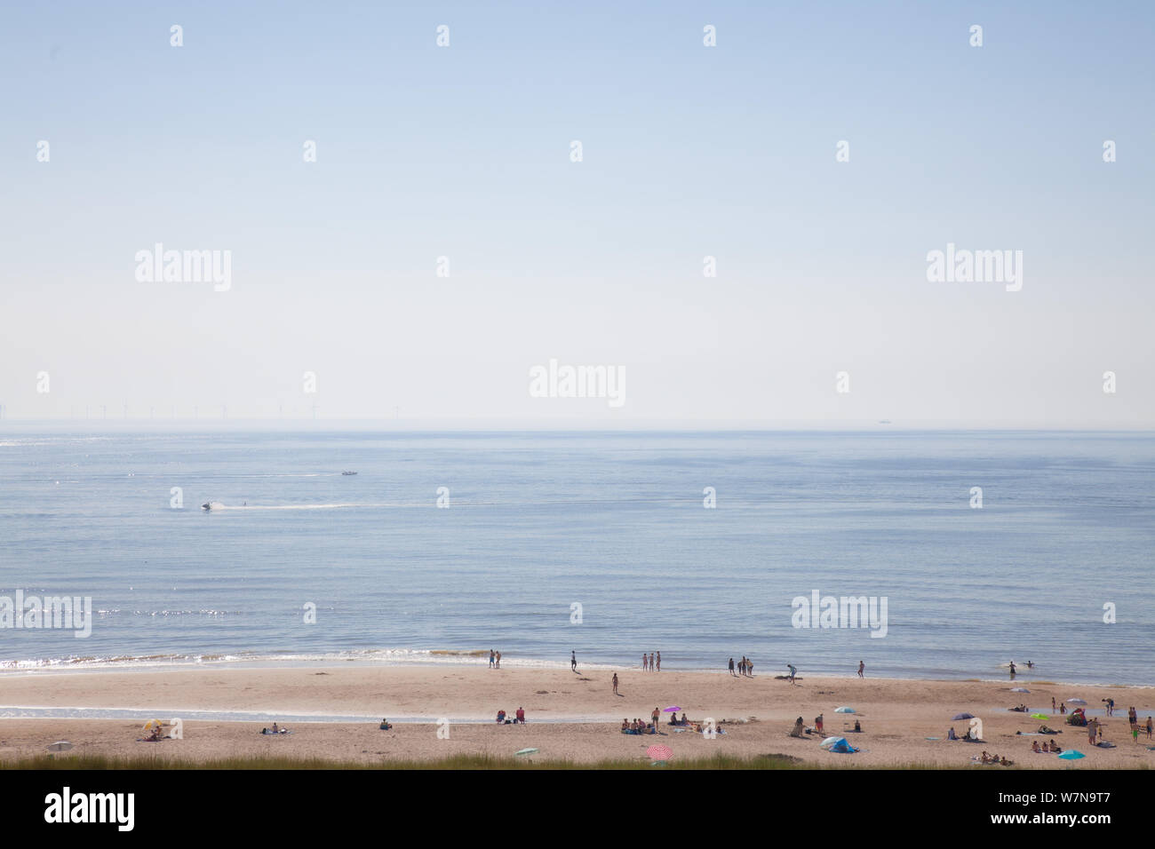 Egmond aan Zee, Netherlands - bathing people on the beach in the glistening sun (high key exposure) Stock Photo