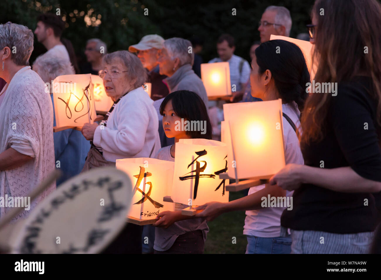 Participants gather with paper lanterns at the Toro Nagashi Lantern Floating Ceremony in Seattle, Washington on August 6, 2019. “From Hiroshima To Hope” is held in remembrance of atomic bomb victims on the anniversary of the bombing of Hiroshima, Japan. The ceremony, organized by a collation of peace, religious, civil liberties and cultural heritage organizations, honors victims of the bombings of Hiroshima and Nagasaki, and all victims of violence. It is an adaptation of an ancient Japanese Buddhist ritual, the Toro Nagashi, in which lanterns representing the souls of the dead are floated out Stock Photo