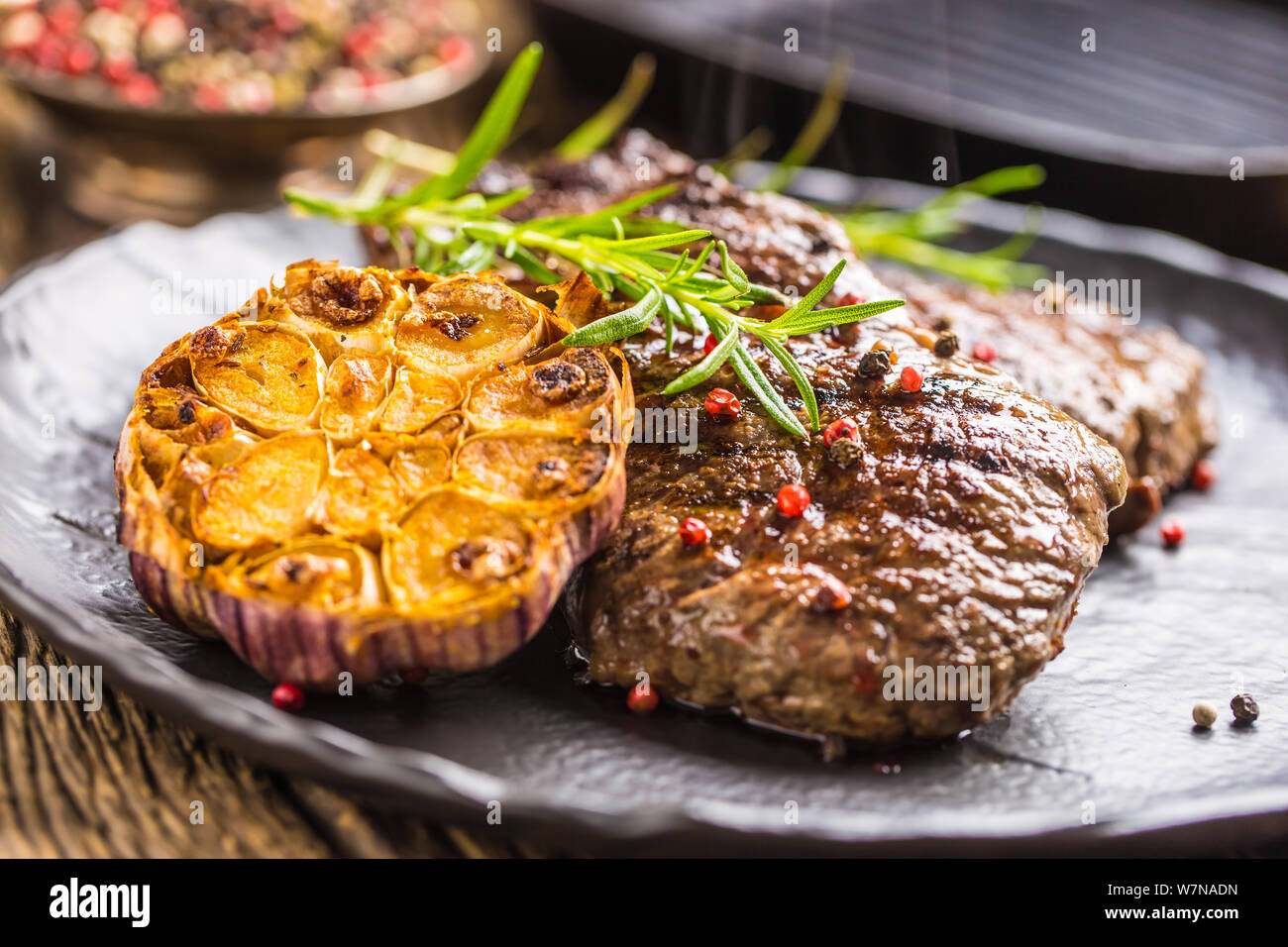 Grilled beef Rib Eye steak with garlic rosemary salt and spices Stock Photo