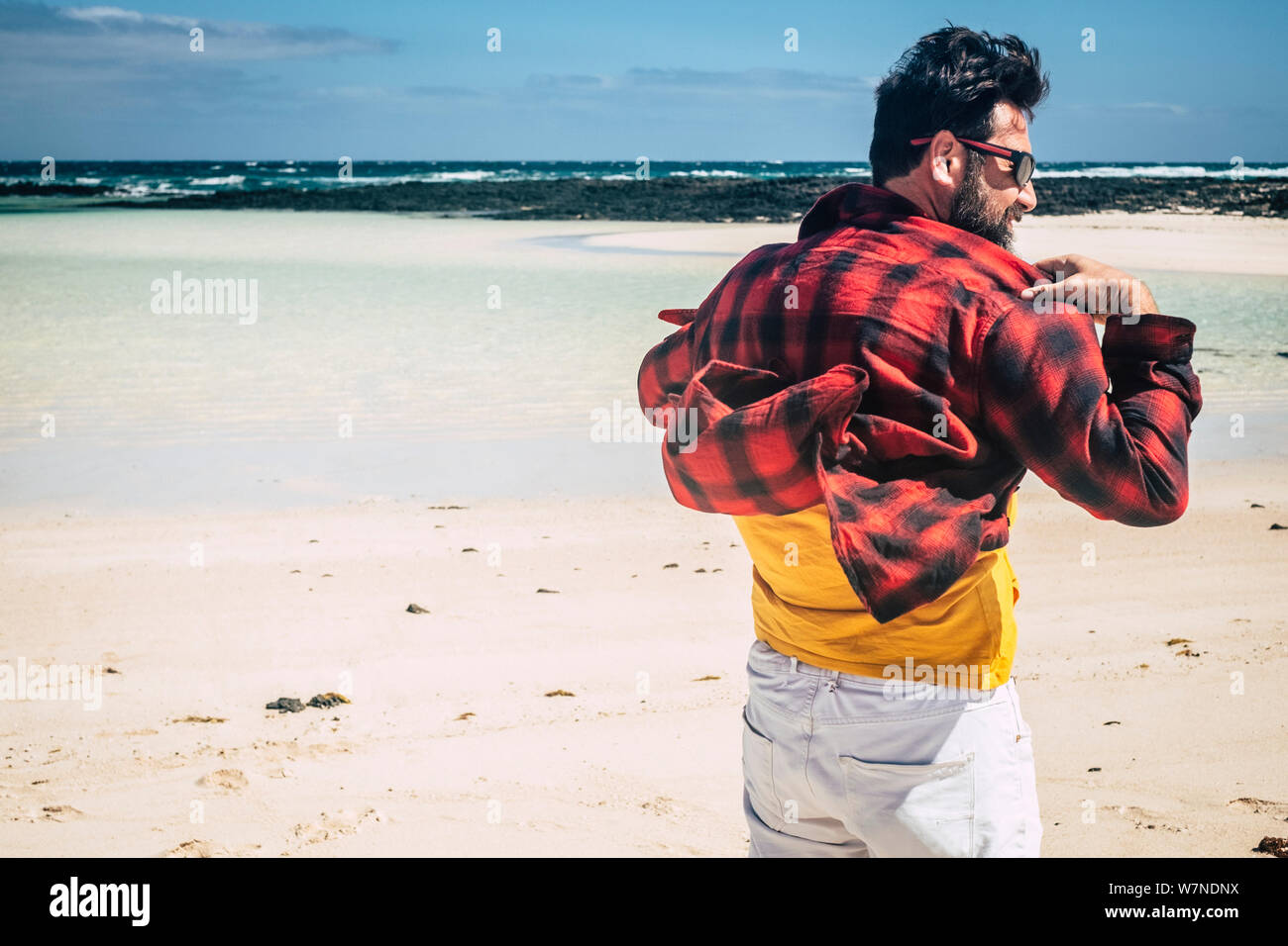 Adult man viewed from back enjoying the beach and the nature with ...