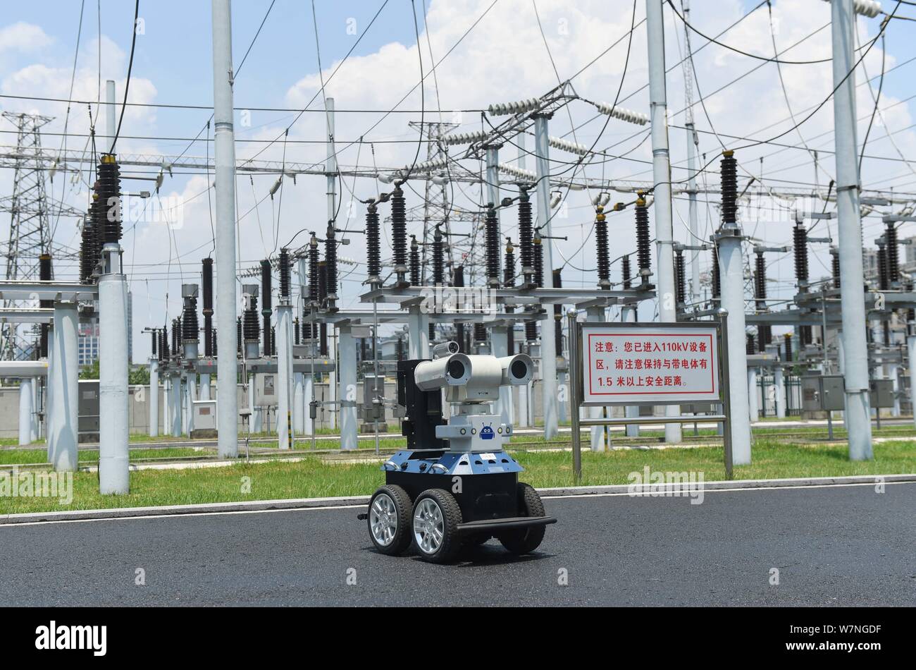 A robot is pictured as it is used to help Chinese workers check the substation during the scorching days at a power transformer substation in Chuzhou Stock Photo