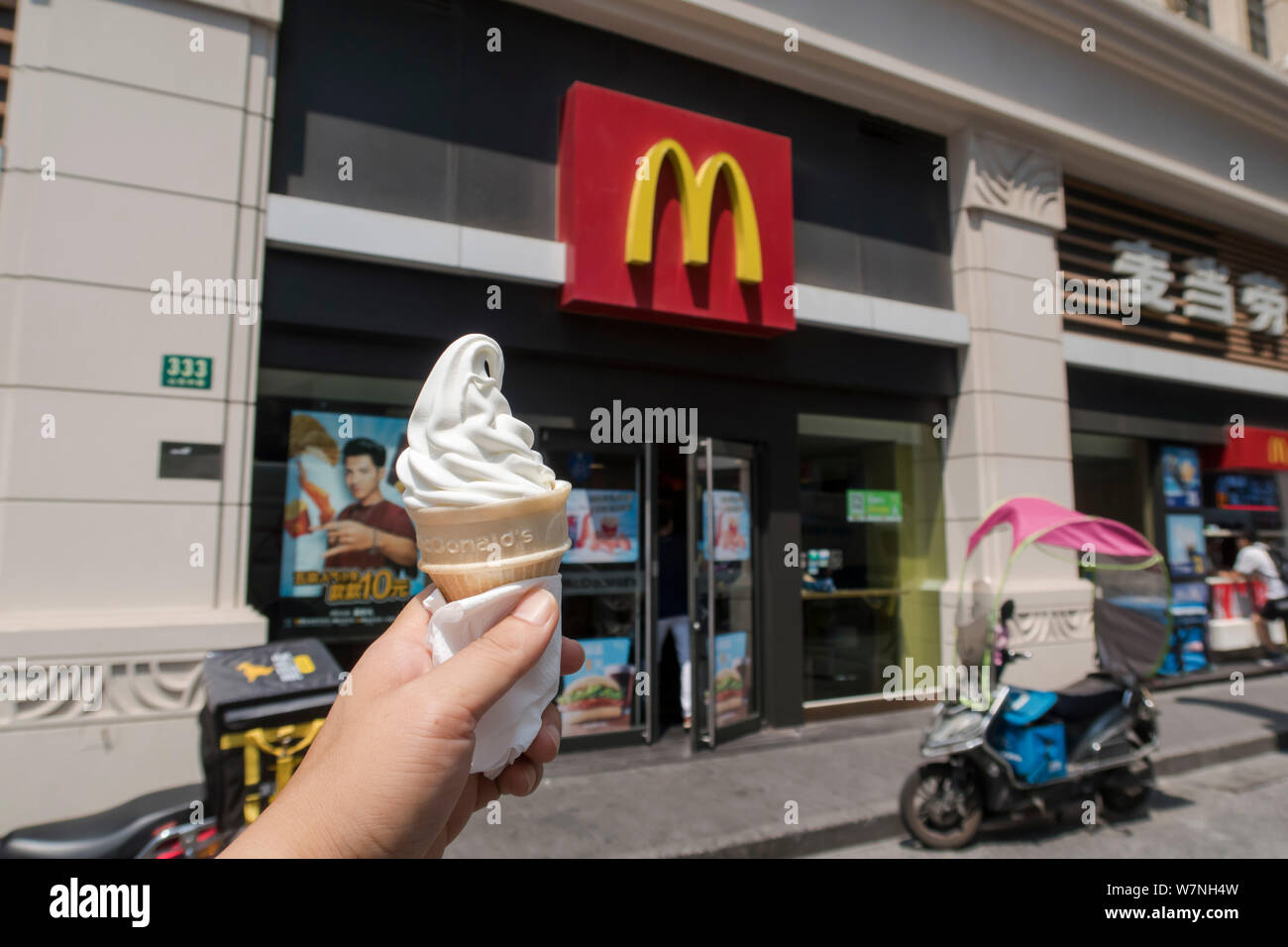 A Customer Holds An Ice Cream Of Mcdonald S In Front Of A Mcdonald S Fastfood Restaurant In Shanghai China 27 July 2017 Viral Photos And News Rep Stock Photo Alamy