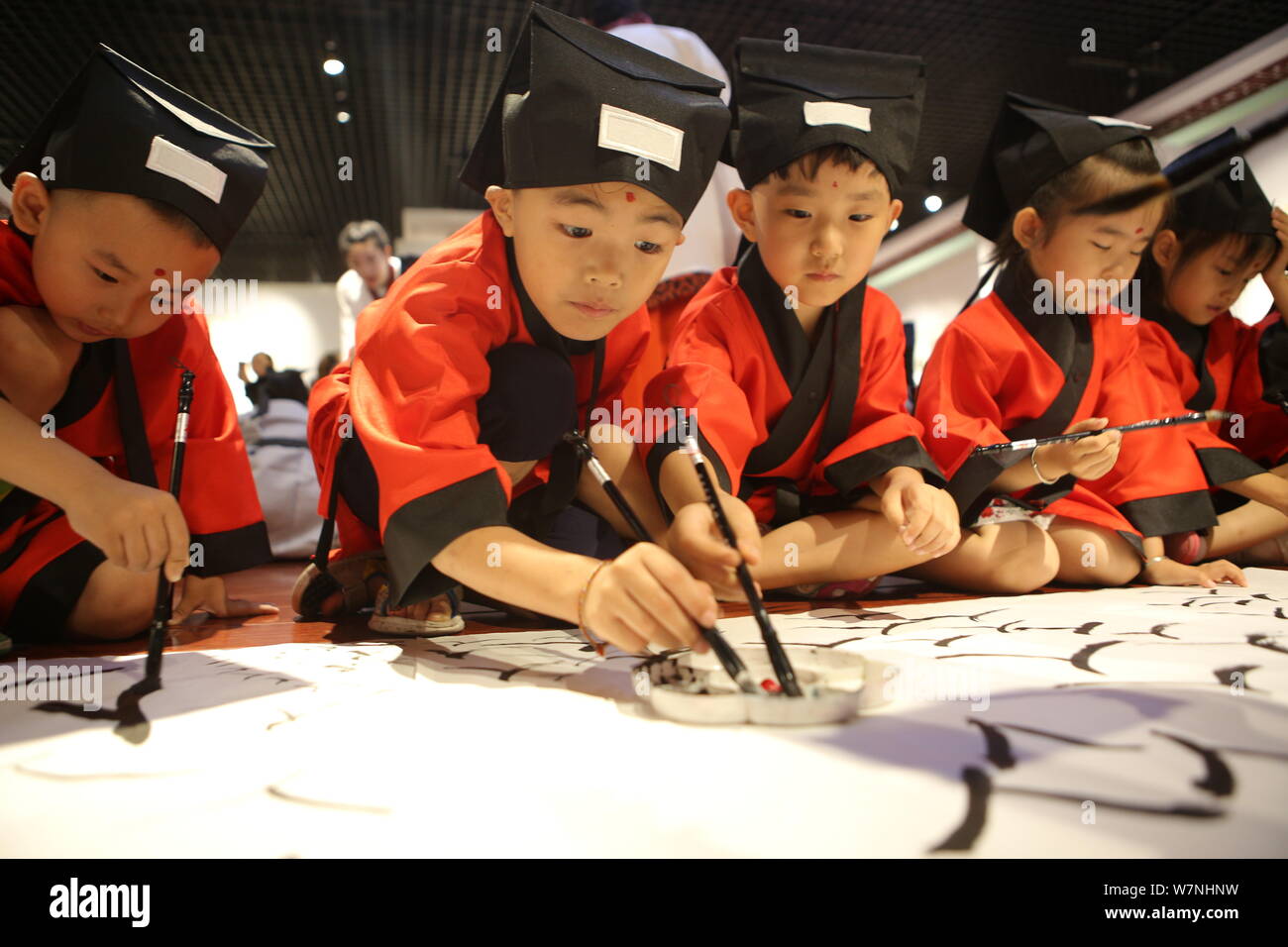 Students write the Chinese character "Ren," meaning "Human" in English