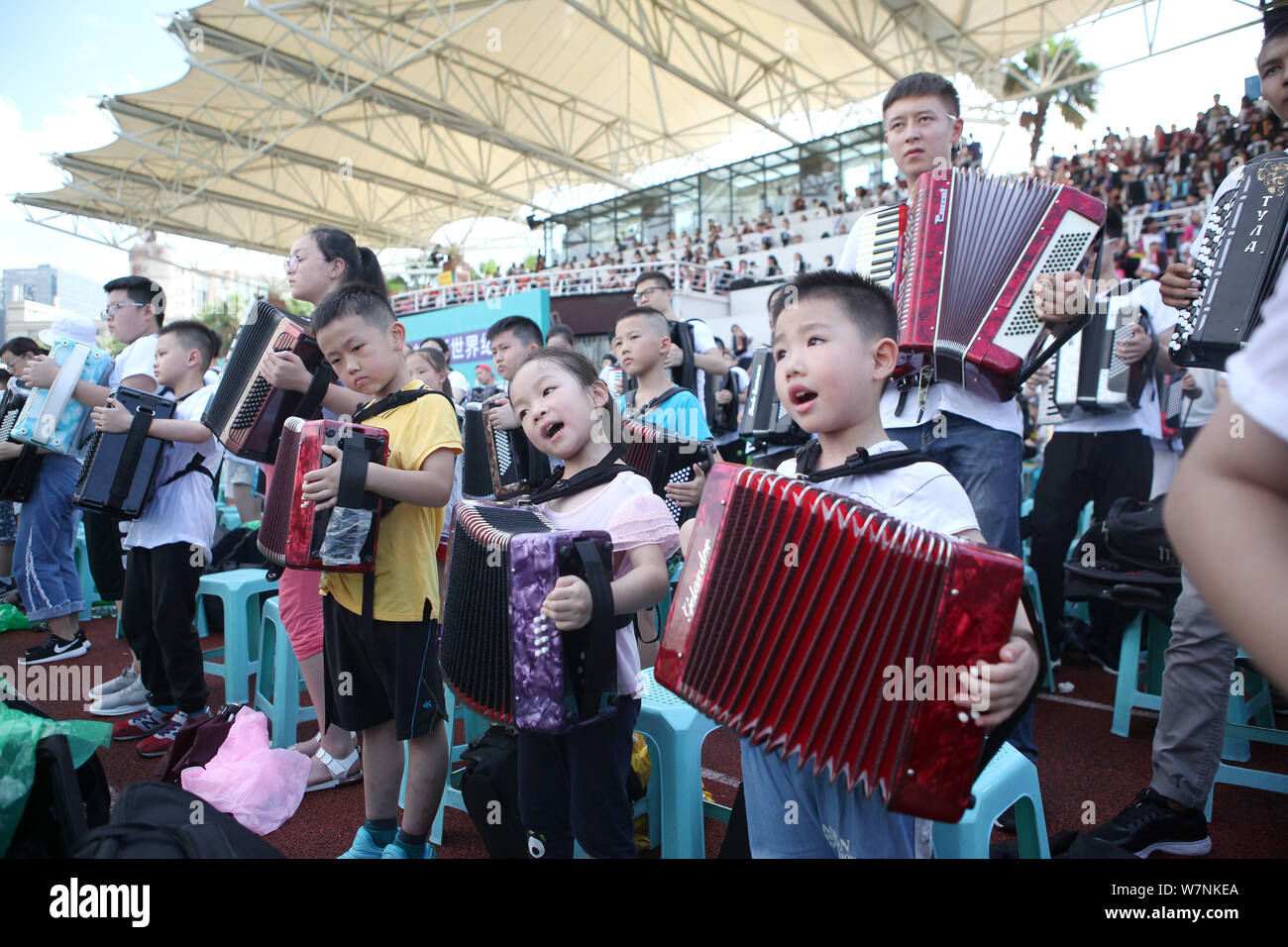 Participants play the accordion during an attempt to set a new Guinness