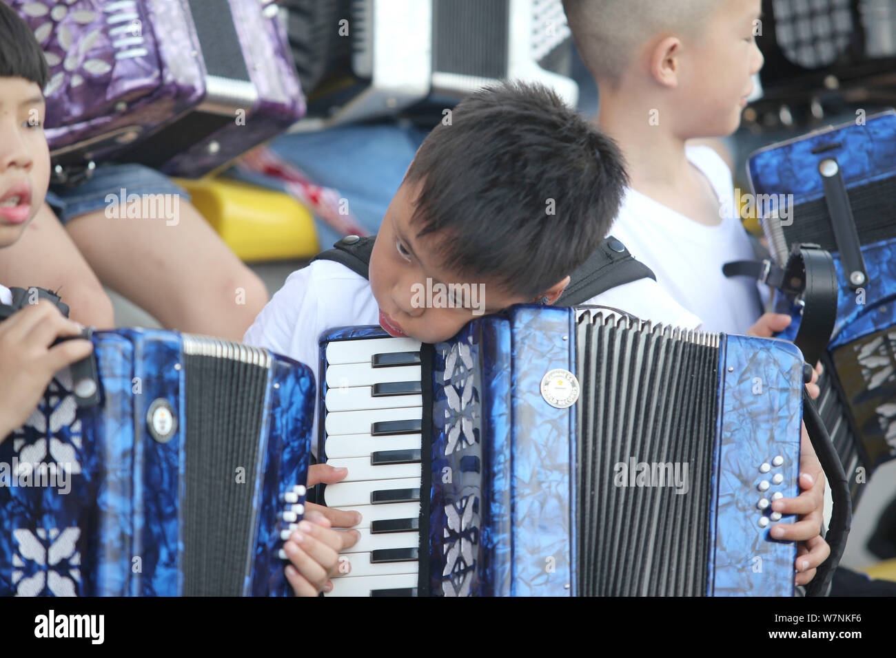 Participants prepare to play the accordion during an attempt to set a