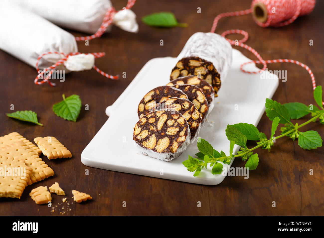 Chocolate salami as traditional dessert with broken biscuits Stock