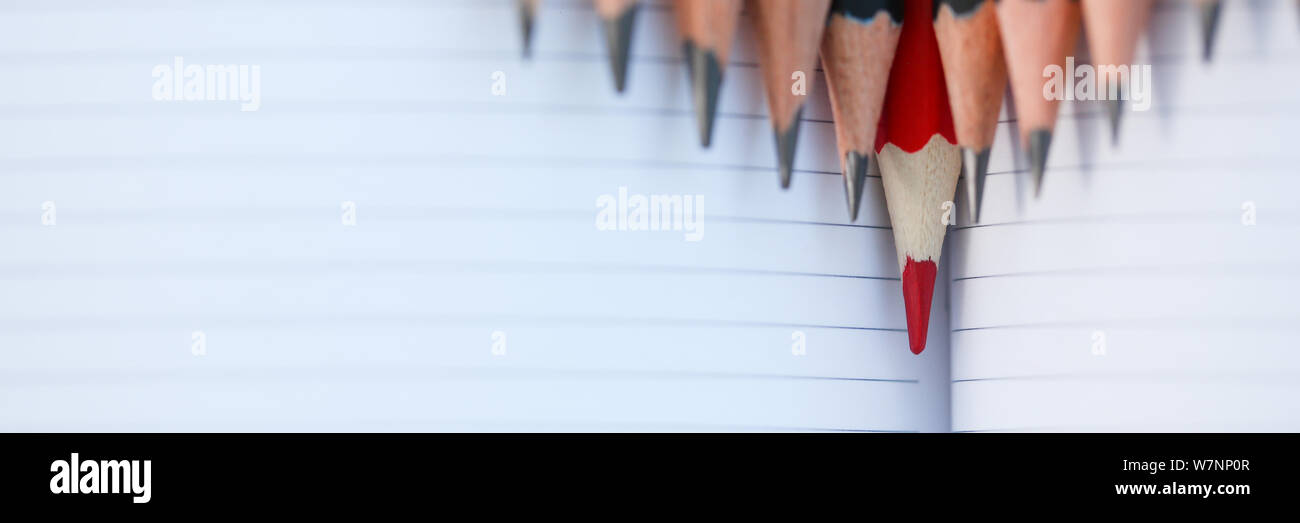Red pencil standing out from crowd of plenty Stock Photo