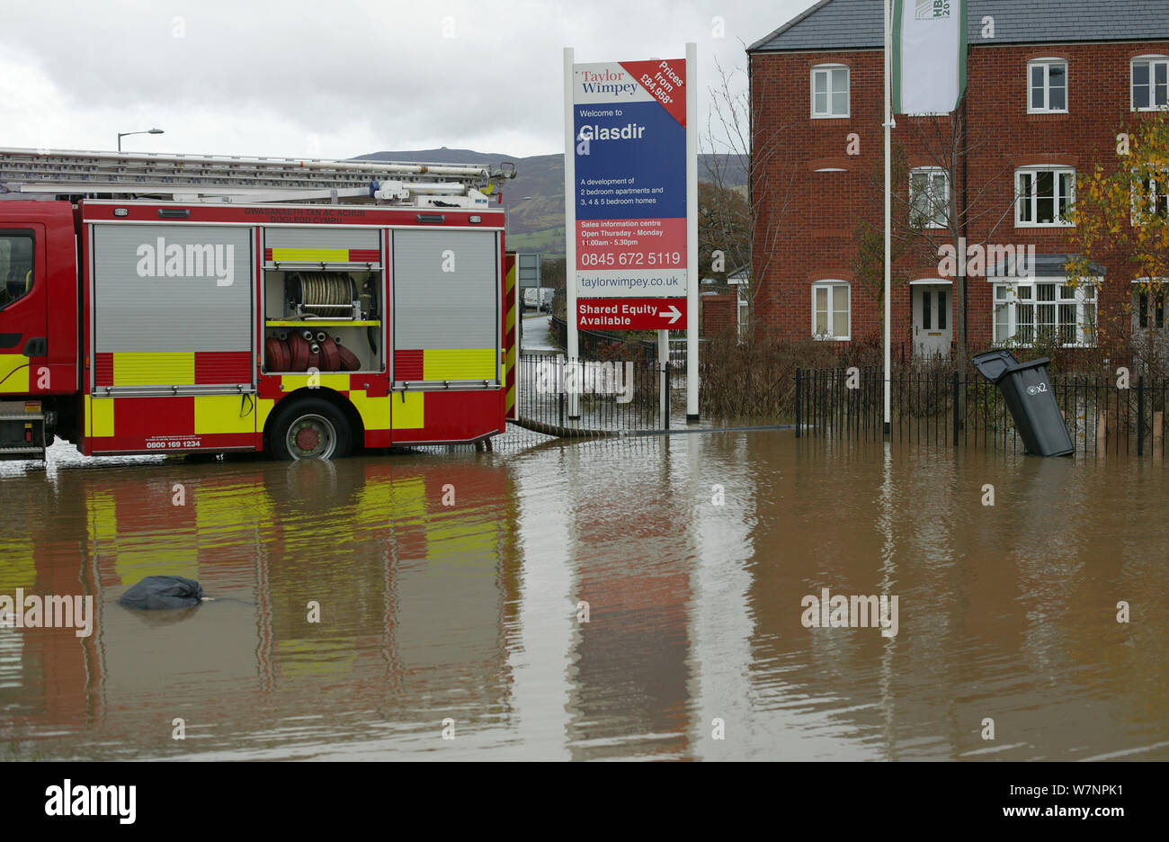 Fire engine working to drain flooding of newly built housing in Glasdir estate, with houses for sale, Ruthin, Vale of Clwyd, Denbighshire, Wales, UK.  This is an area at risk of flooding and therefore difficult to obtain House insurance. 27/11/ 2012 Stock Photo