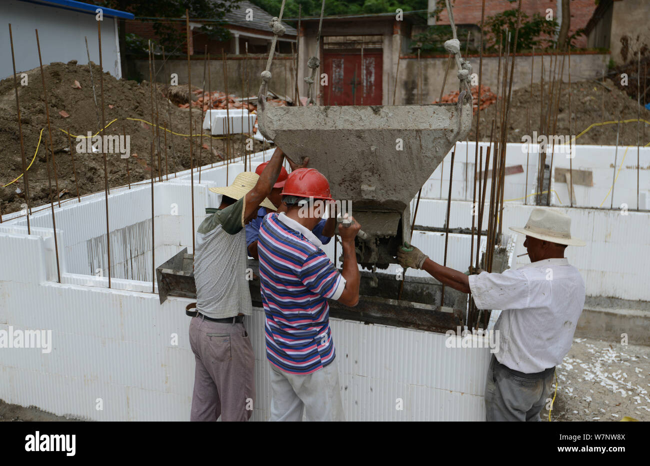 --FILE--Chinese workers build a house with molded expanded polystyrene (EPS), the building insulation materials to reduce heat transfer, in Ziran vill Stock Photo