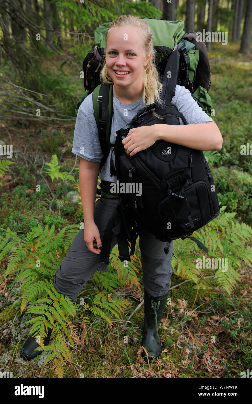 Liisa Widstrand, carrying photography equipment, Karmansbo, Vastmanland, Sweden August 2011. Model released Stock Photo