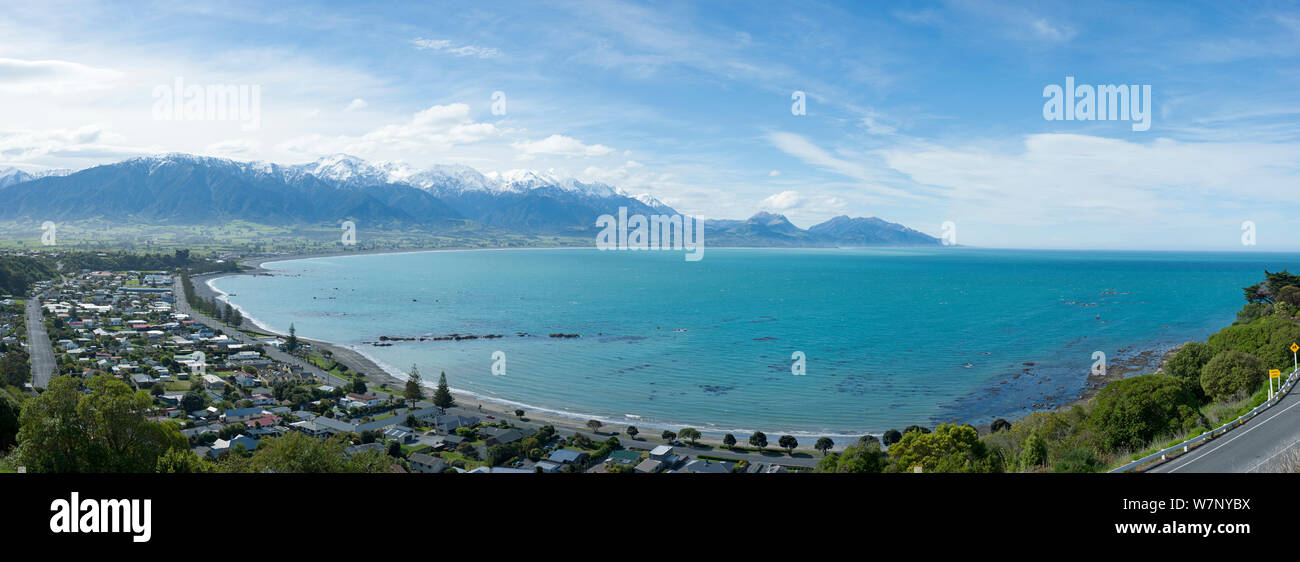 Wide angle view of coastline, town and mountains. Kaikoura, New Zealand, October. Stock Photo