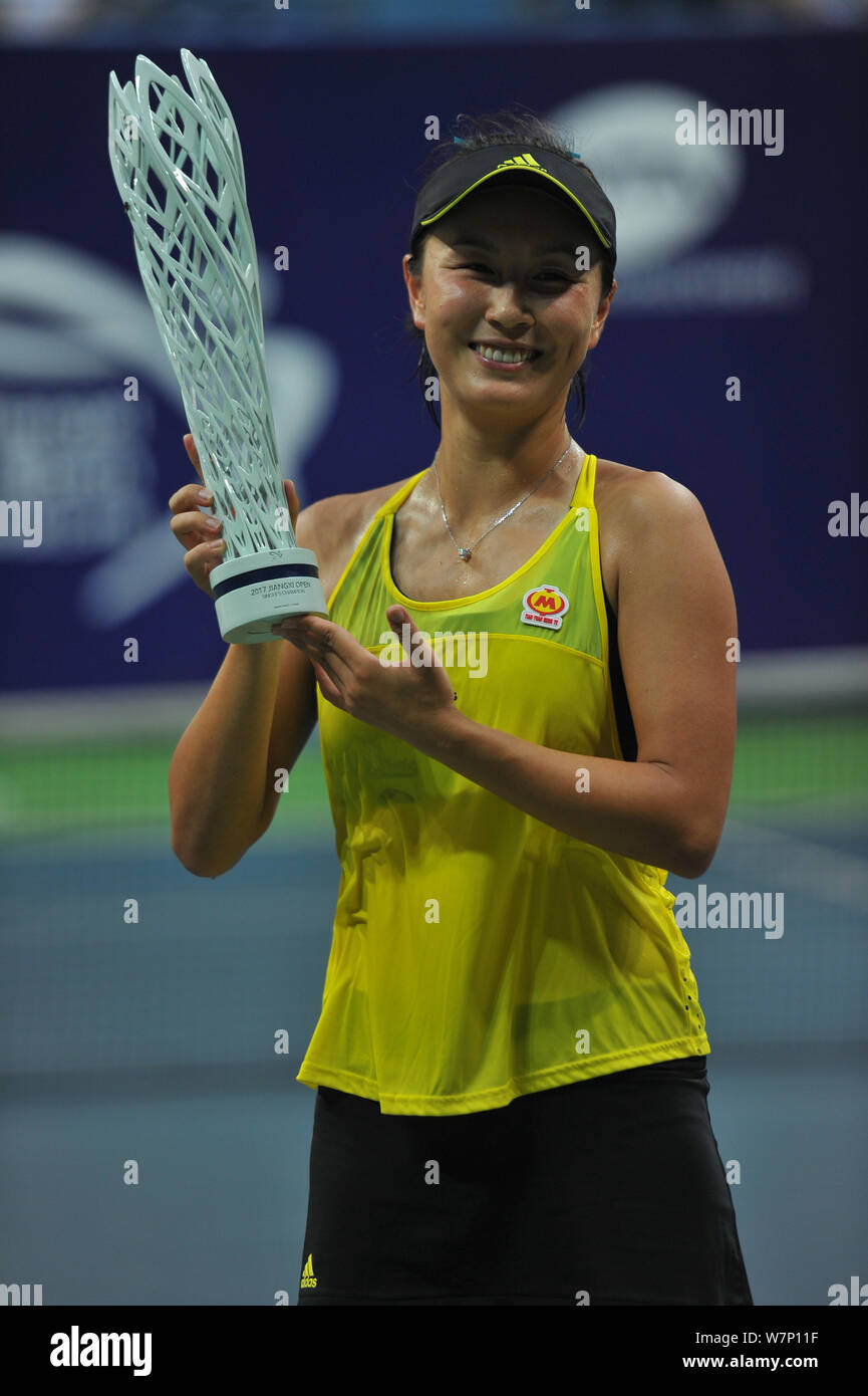 Peng Shuai of China poses with her champion trophy after defeating Nao