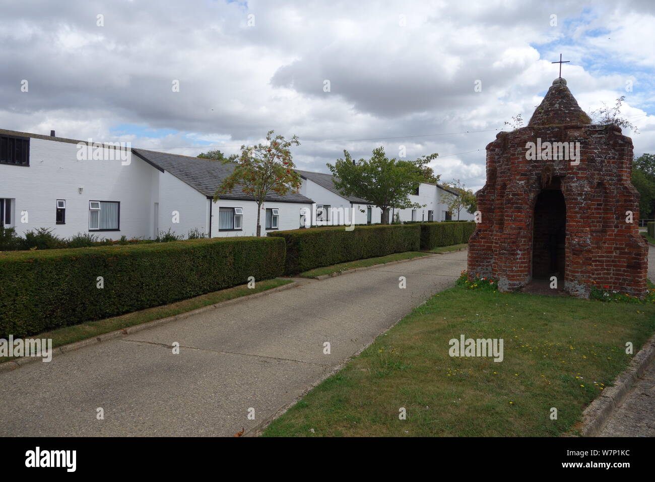 Rushbrooke Suffolk estate housing around brick medieval wellhead from