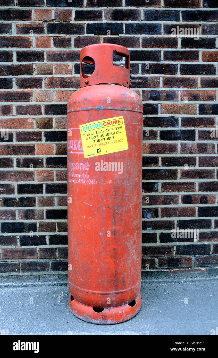 Envirocrime label stuck onto a cylinder with inflammable contents dumped in street, London Borough of Islington, UK Stock Photo