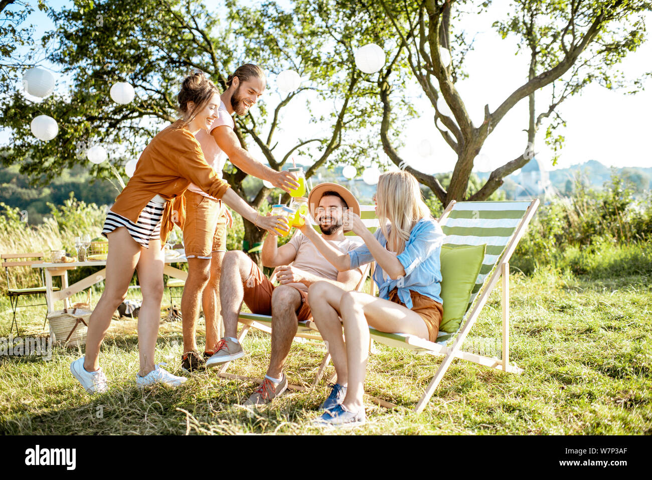 Friends hanging out, enjoying picnic - Stock Image - F020/2364 - Science  Photo Library