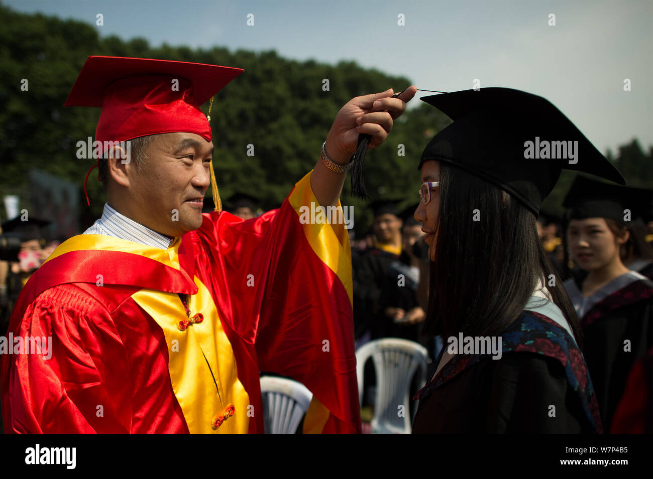 A graduate dressed in an academic gown takes part in the turning of the  tassel ceremony during a graduation ceremony at Wuhan University in Wuhan  city Stock Photo - Alamy