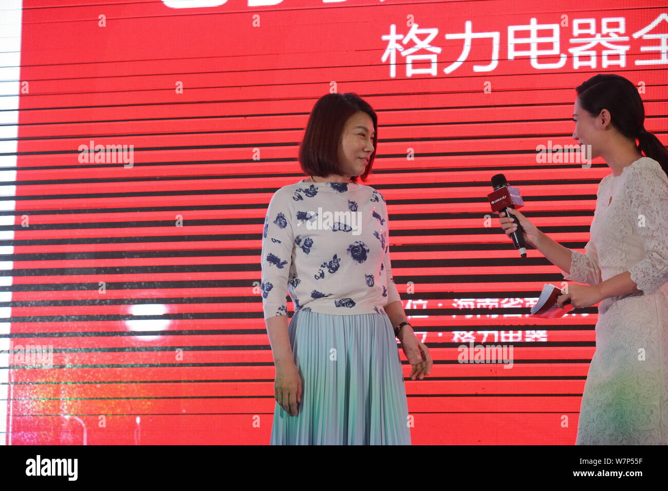 Dong Mingzhu, left, Chairwoman and President of Gree Electric Appliances Inc., is pictured as she prepares to deliver a speech during the opening cere Stock Photo