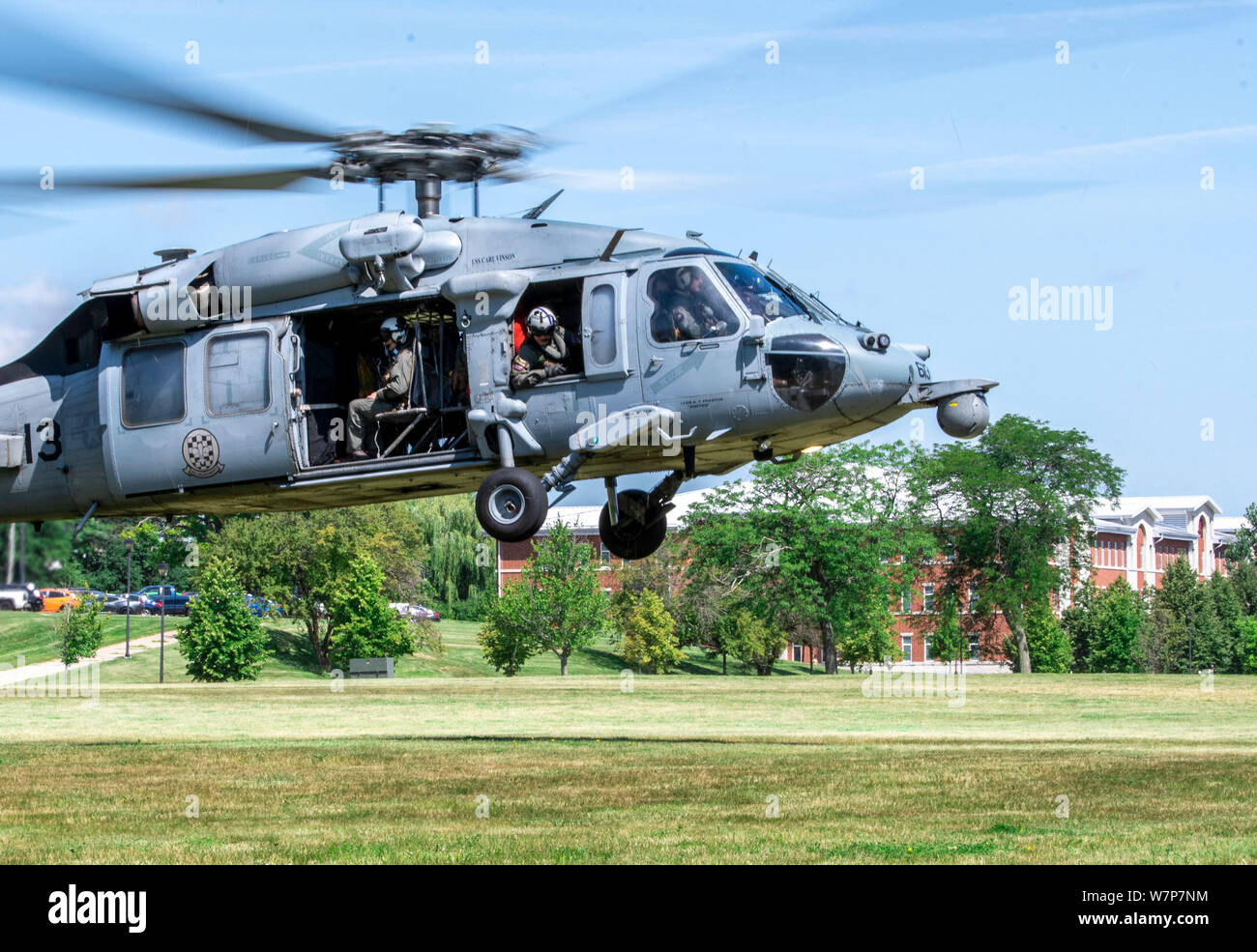 190802-N-PL946-2064 GREAT LAKES, Ill. (Aug. 2, 2019) An MH-60S Seahawk helicopter from the Helicopter Sea Combat Squadron Four (HSC-4) “Black Knights,” stationed in San Diego, prepares to land on one of the lawns at Recruit Training Command to meet with and commission their sponsored recruit division. More than 35,000 recruits train annually at the Navy's only boot camp. (U.S. Navy photo by Mass Communication Specialist 1st Class Spencer Fling/Released) Stock Photo