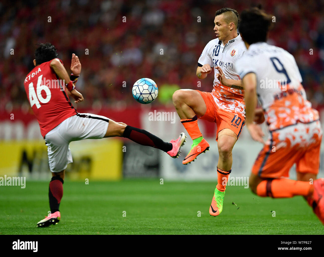 Al Hilal's Ali Al Bulayhi, right, fights for the ball with Urawa