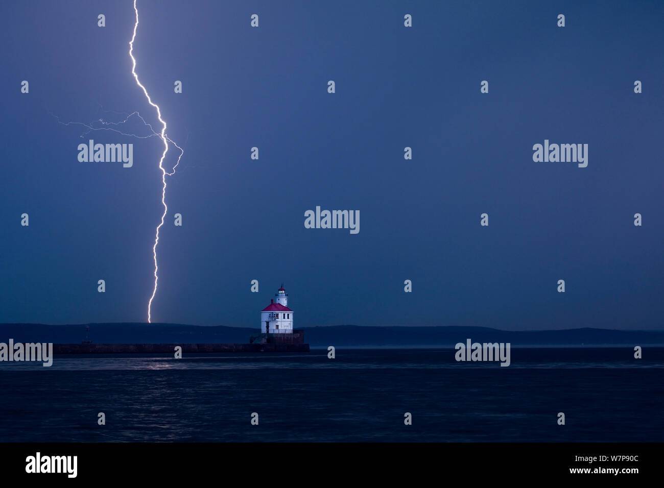 Lightning storm during sunrise at Wisconsin Point Lighthouse on Lake