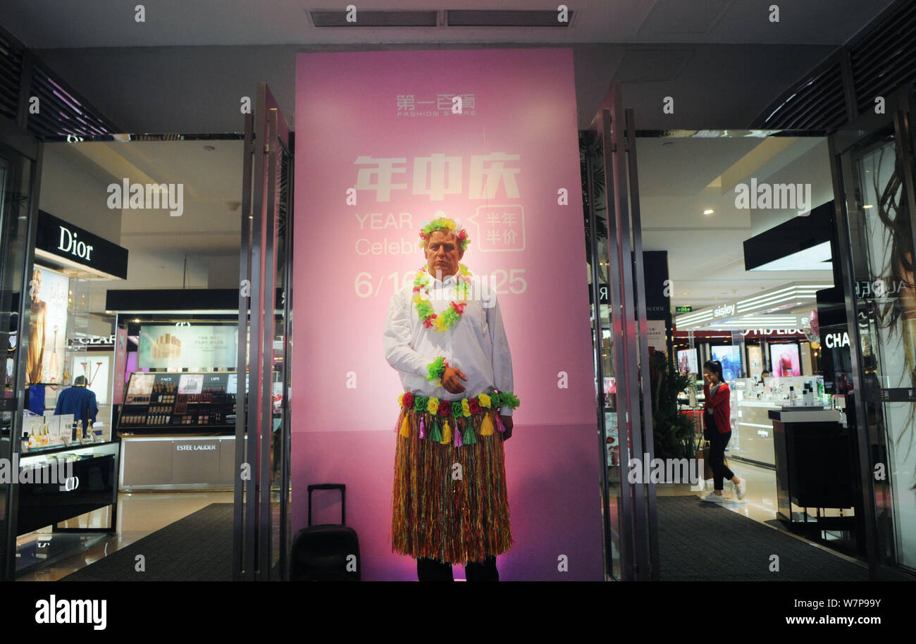 View of a wax figure of U.S. President Donald Trump decorated with a grass skirt with a special facial expression at a shopping mall in Jinhua city, e Stock Photo