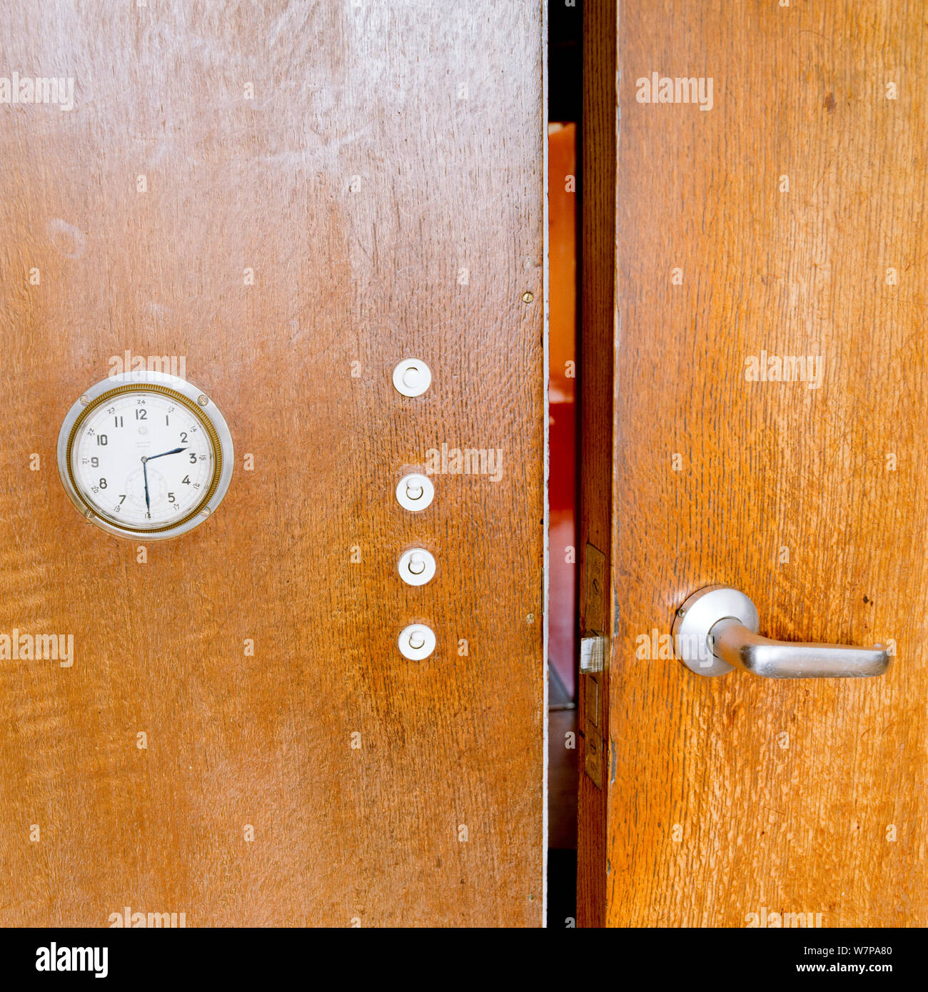 Open wooden cupboard with clock Stock Photo