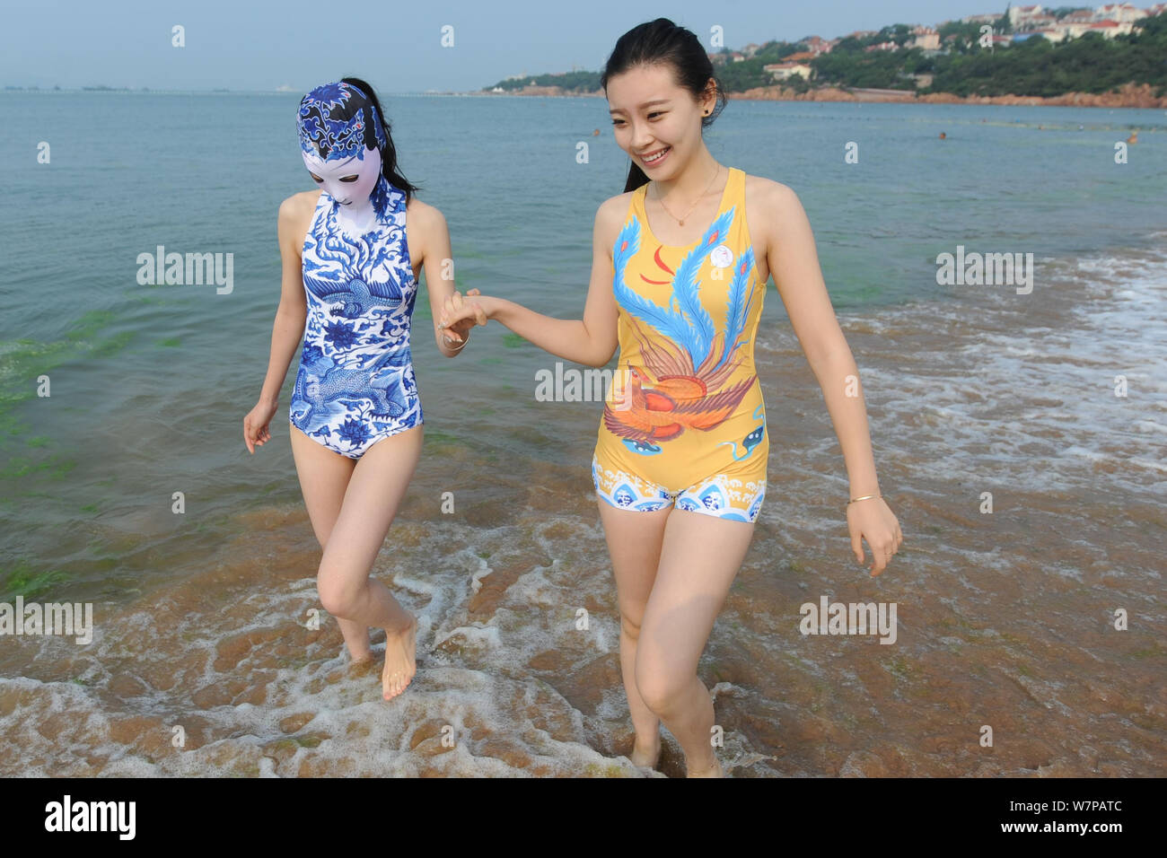 A model, left, wearing a facekini swimsuit featuring blueandwhite