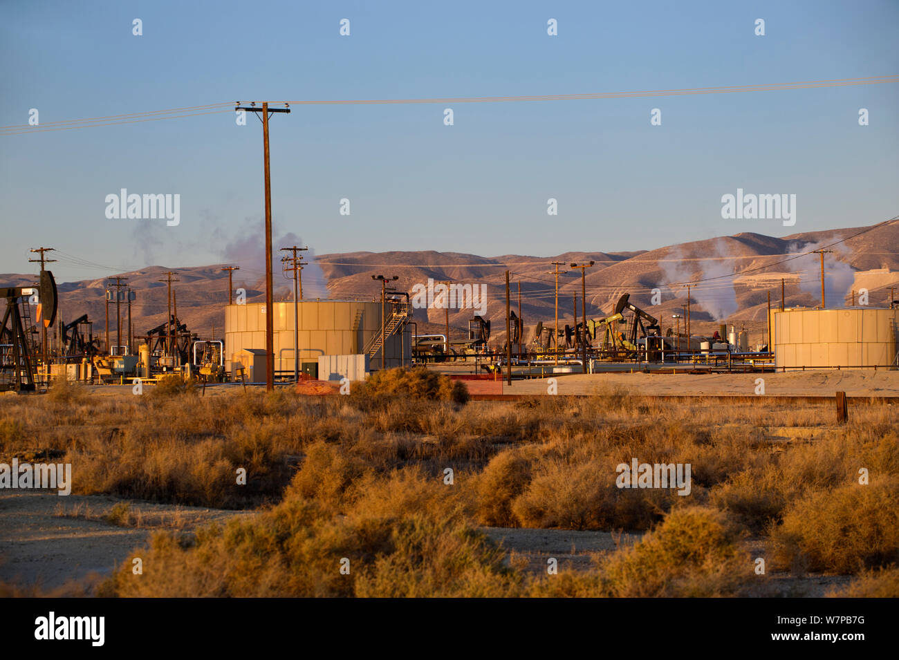 Oil derricks and storage tanks in a working oil field, Southern Kern