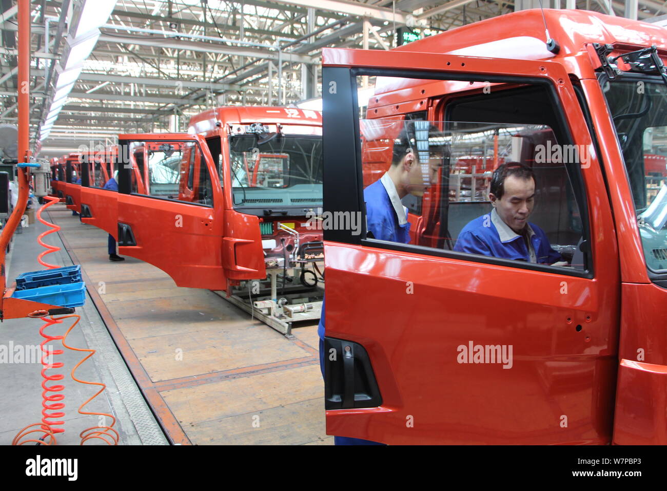 --FILE--Chinese workers assemble trucks on the assembly line at an auto ...