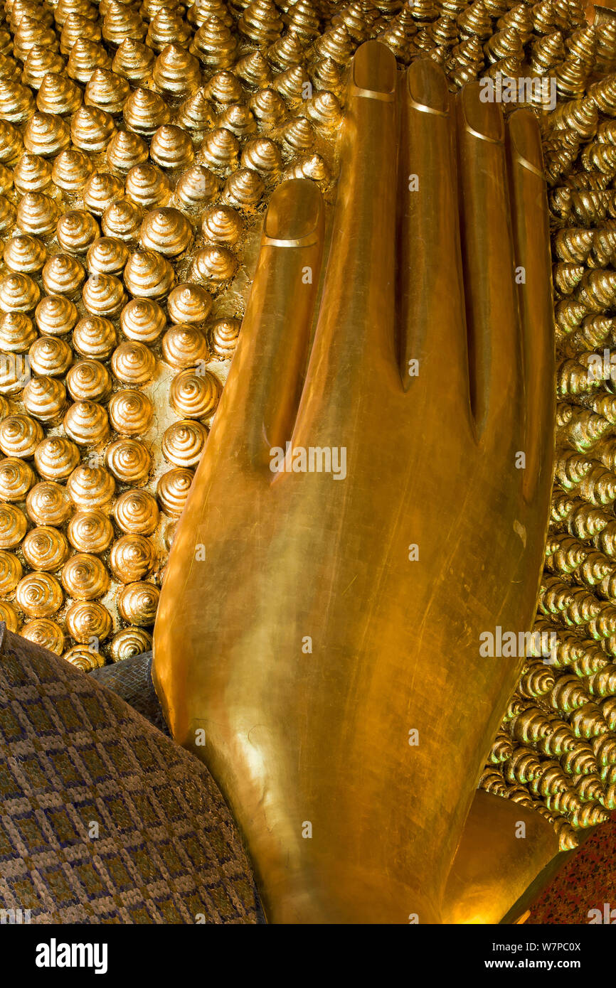 Wat Pho, Reclining Buddha, 46 metres long made of brick plaster and Gold leaf, hand detail.  The soles of the feet are inlaid with 108 lakshana, or auspicious images that identify the true Buddha crafted in mother-of-pearl, Bangkok, Thailand, 2010 Stock Photo