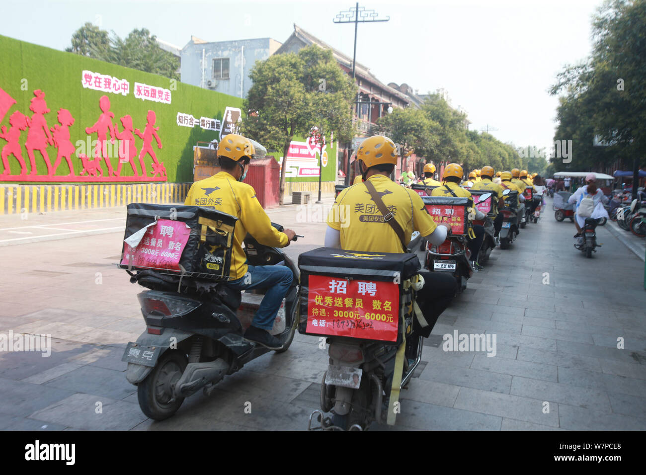 A Group Of Food Delivery Couriers Of Chinese Online Food Delivery Company Meituan Waimai Ride Electric Bikes To Deliver Meals On A Road In Kaifeng Cit Stock Photo Alamy