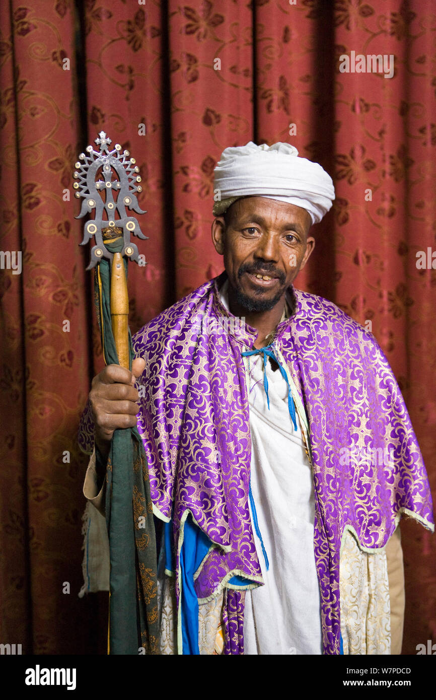 Priest in Bet Danaghel Church holding the Cross of King Lalibela. The  rock-hewn churches of Lalibela make it one of the greatest  Religio-Historical sites not only in Africa but in the Christian