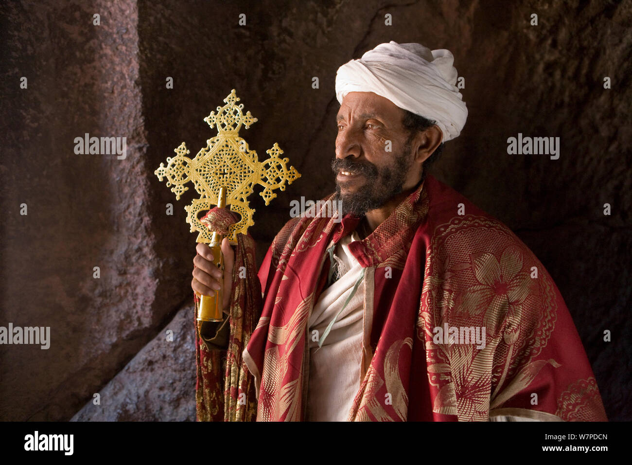 Priest in Bet Danaghel Church holding the Cross of King Lalibela. The  rock-hewn churches of Lalibela make it one of the greatest  Religio-Historical sites not only in Africa but in the Christian