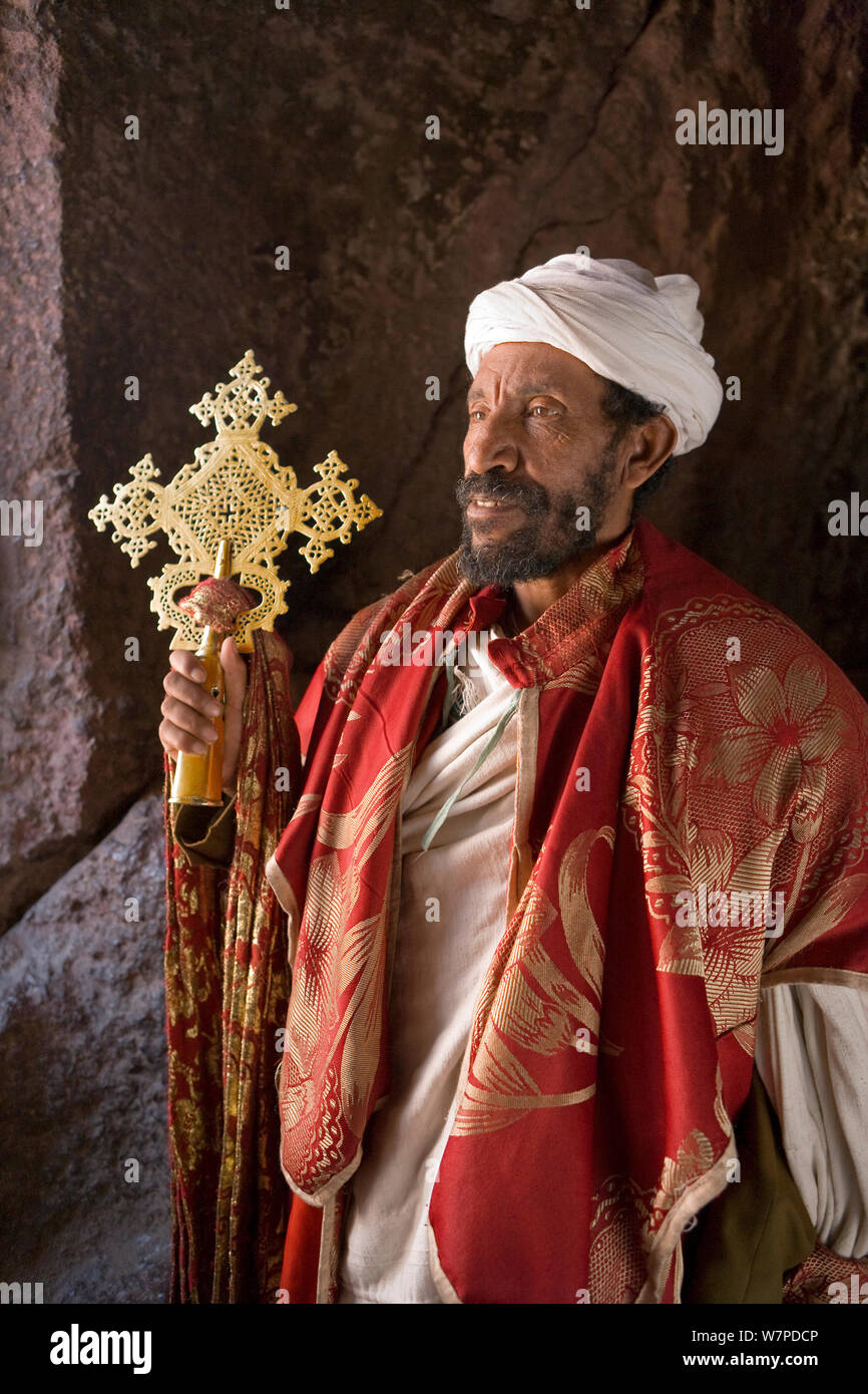 Priest in Bet Danaghel Church holding the Cross of King Lalibela. The  rock-hewn churches of Lalibela make it one of the greatest  Religio-Historical sites not only in Africa but in the Christian