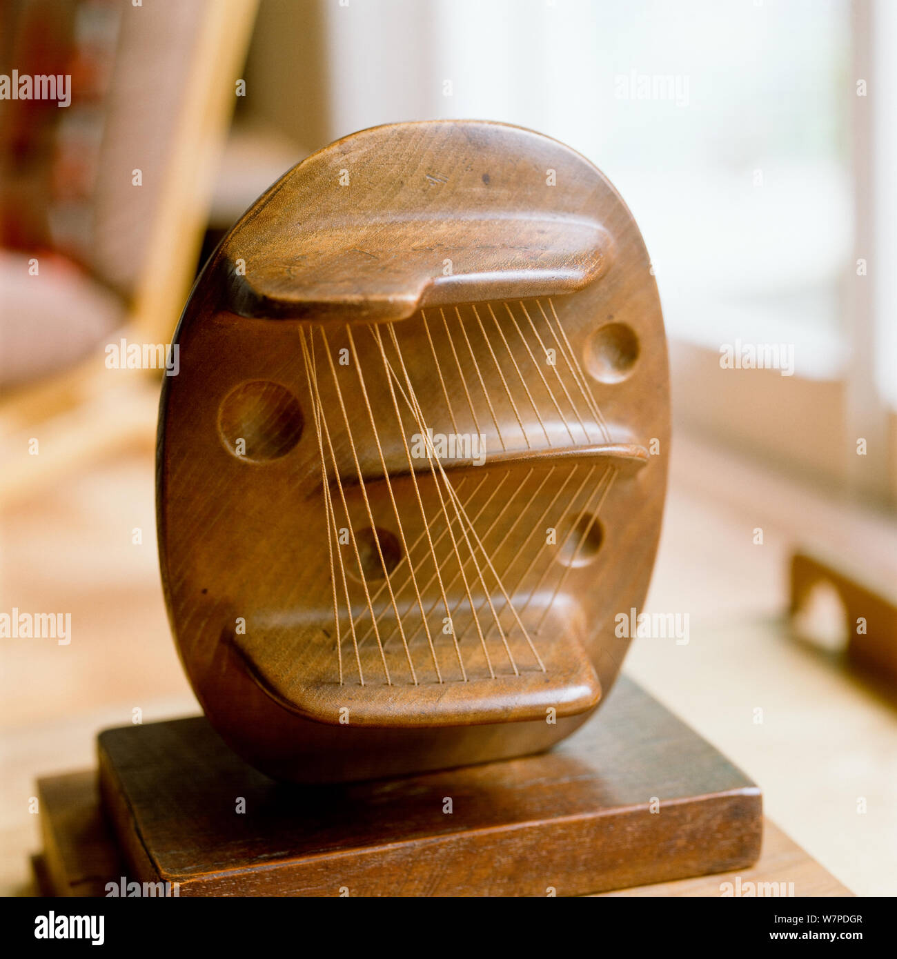 Wooden abstract sculpture with strings Stock Photo