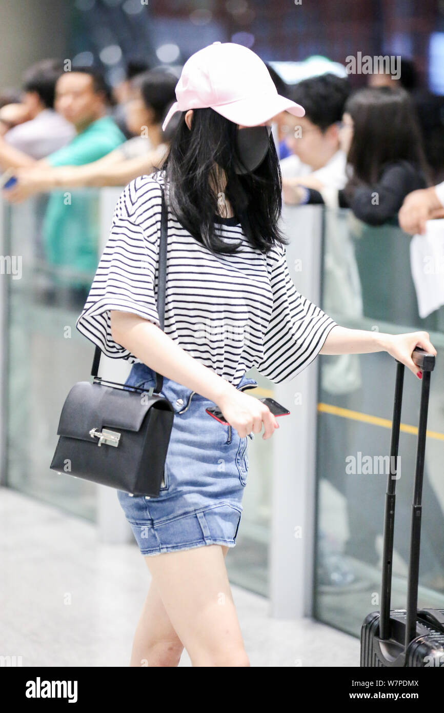 Chinese actress Yang Mi is pictured at the Beijing Capital International Airport in Beijing, China, 29 June 2017.   Tee shirt: R13  Skirt: RtA  Shoes: Stock Photo
