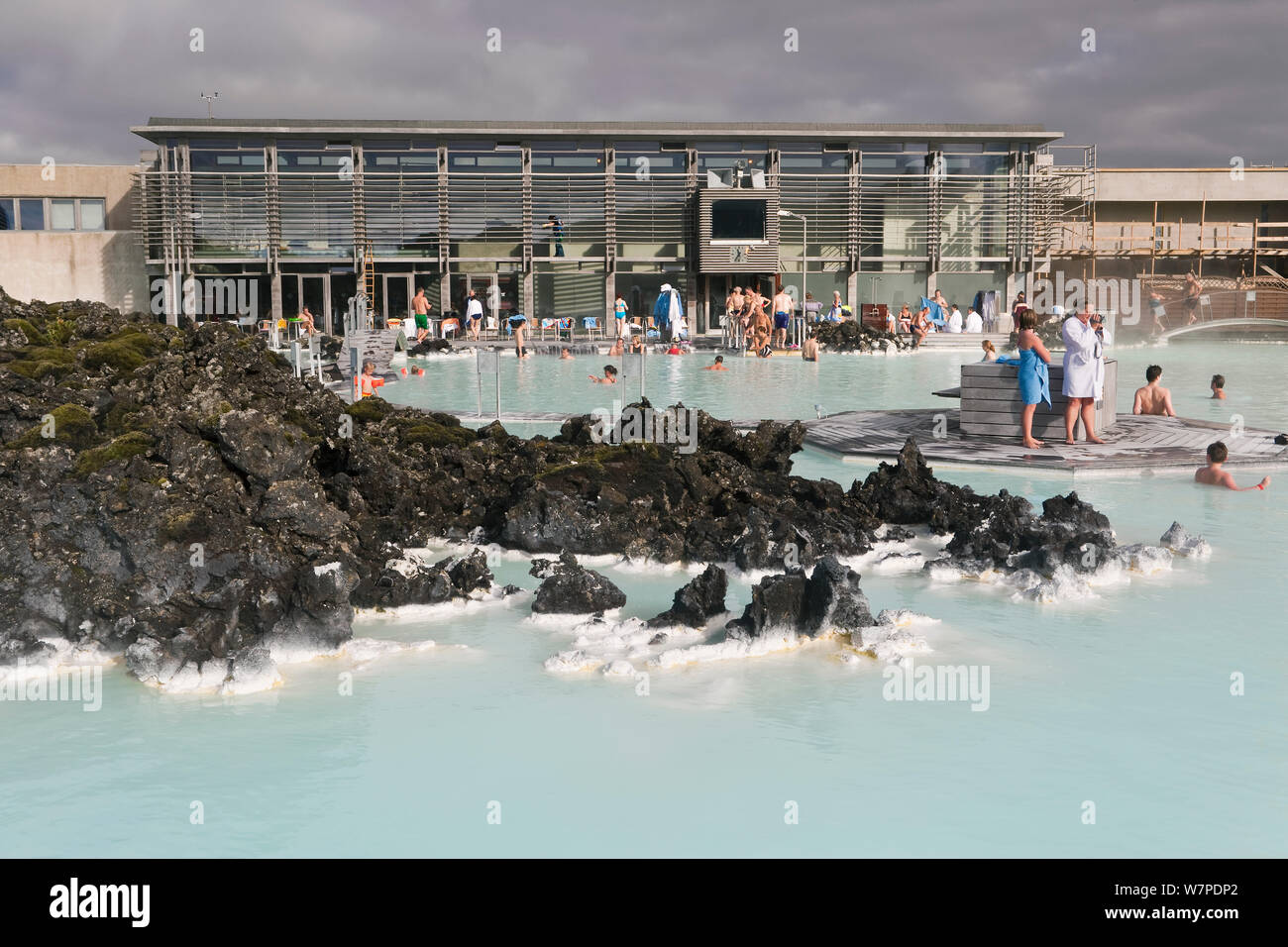 The Blue Lagoon, Iceland's most famous tourist attraction is located among the black lava flows outside Reykjavik. The geothermal spa owes its existence to the Svartsengi geothermal power plant powered by superheated seawater drawn from deep bore holes in the lava. The milky blue waters are rich in blue-green algae (cyanobacteria), mineral salts and fine silica mud. Reykjavik, Iceland 2006 Stock Photo
