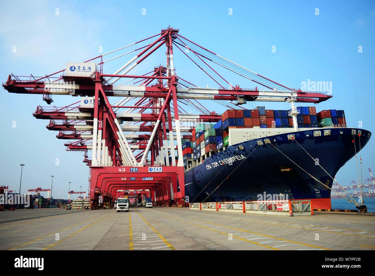 A cargo ship loaded with containers to be shipped abroad berths at the Port of Qingdao in Qingdao city, east China's Shandong province, 7 June 2017. Stock Photo