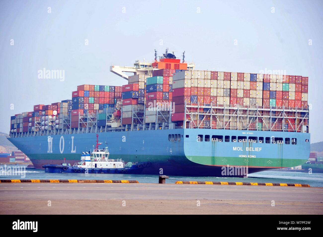 A cargo ship loaded with containers to be shipped abroad is docked on a quay at the Port of Qingdao in Qingdao city, east China's Shandong province, 7 Stock Photo