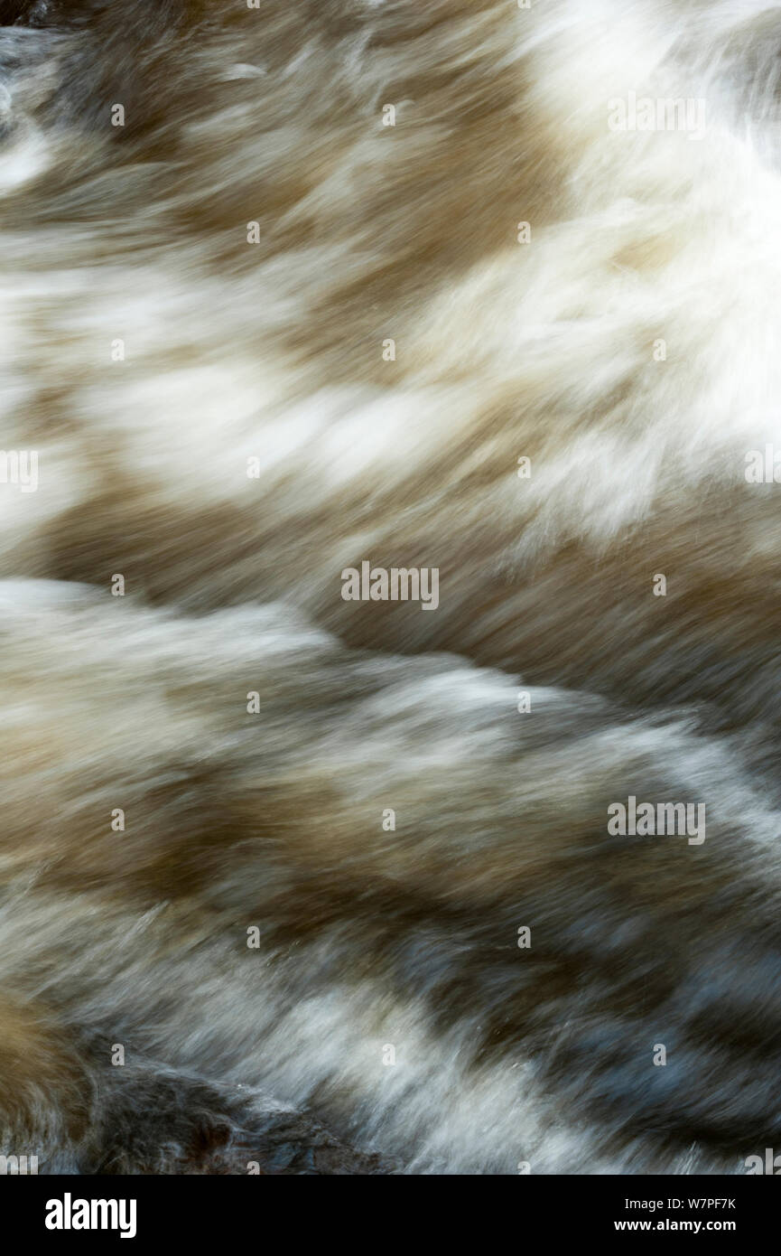 River in full spate  flowing fast in winter, water close up,  Gannochy winter, Scotland, February. Stock Photo