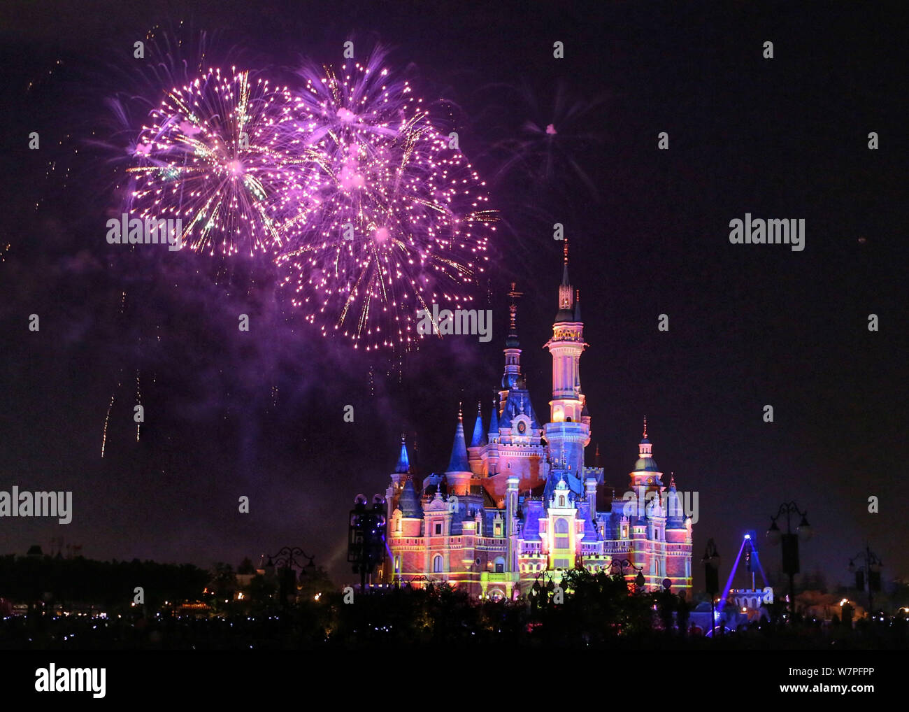 Fireworks explode over the Disney Castle during the first anniversary