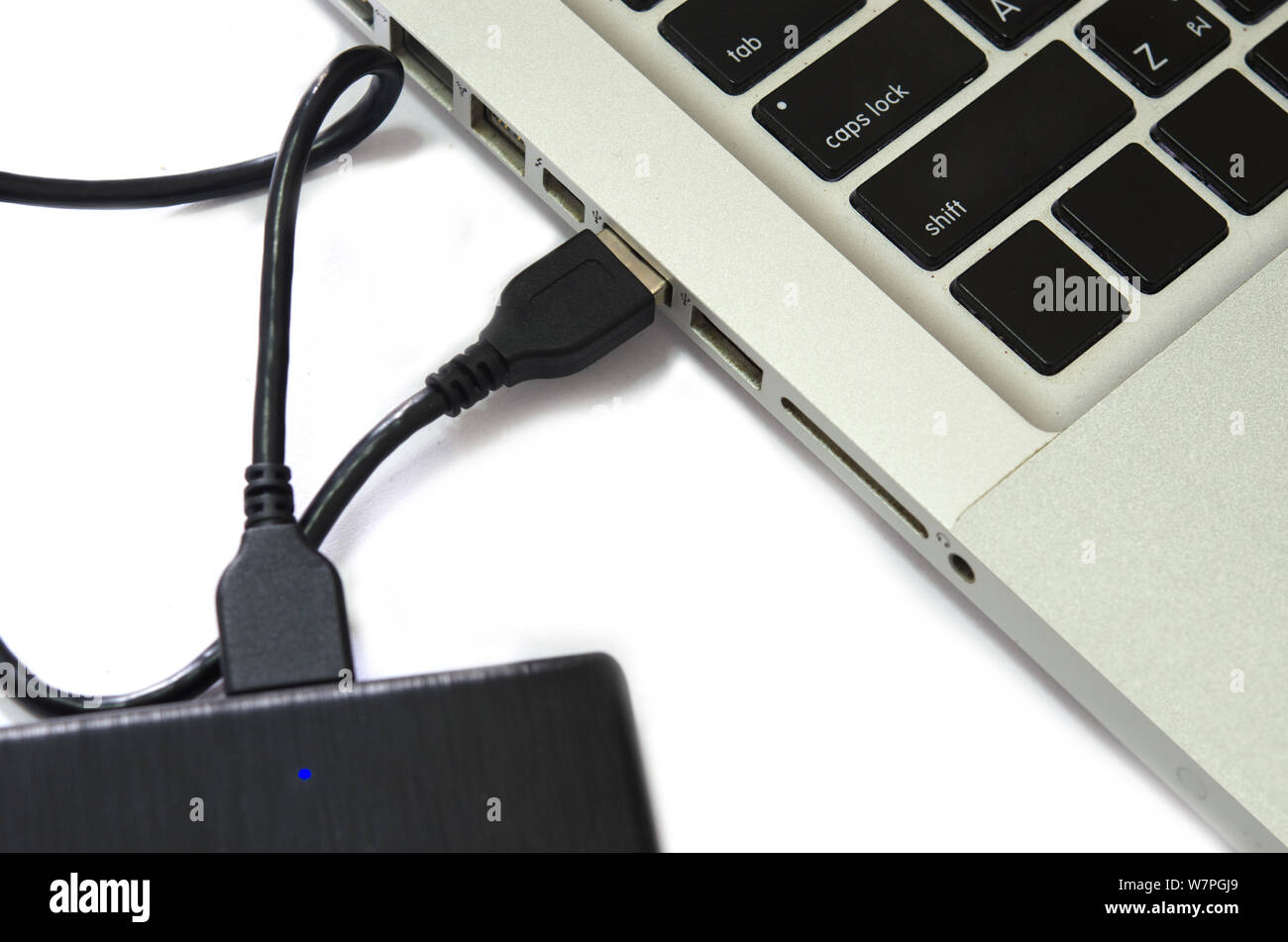 External hard drive connect to laptop computer on the white background